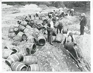 Workers Spilling Seized Beer