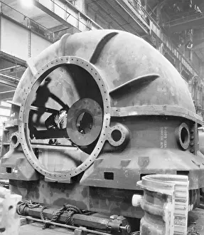 Workman Standing Inside of an Exhaust Shell