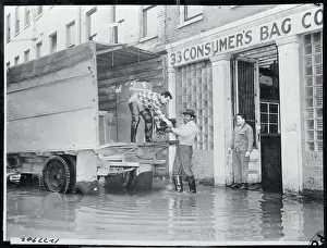 Workmen Loading Merchandise onto Truck
