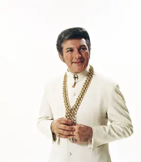 Liberace Prints: World Famous Liberace Posing in White on White Set
