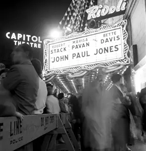Prints of NEW YORK, NY - JUNE 1959: Crowds wait outside the Rivoli Theater at 1620 Broadway for the world premiere of the movie John Paul Jones, starring Bette Davis, Robert Stack, and Marisa Pavan Portraits, Artworks, and Montages from a Visionary Photographer: World Premiere of Movie John Paul Jones At Rivoli Theater in 1959