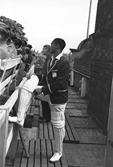 Prints of June 1950: West Indian batsman Frank Worrell (1924 - 1967), waiting to bat against Cambridge University at Fenners. Original Publication: Picture Post - 5056 - Fine Weather Cricketers - pub A Photographic Legacy: Worrell Waiting