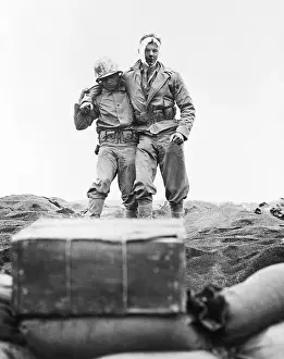 Wounded Soldier Helped To The Beach