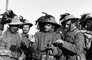 Prints of (Original Caption). Portrait of Italian Bersagliere, in plumed hats, examining aero-darts dropped by Austrian airmen. Undated photograph Unveiling History: Wwi Italian Soldiers Examining Aerodarts