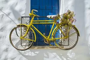 Yellow bike on the wall in Naxos, Greece
