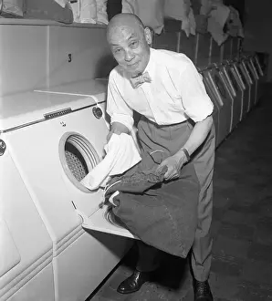 Ying H. Wen Taking Clothing Out of Dryer