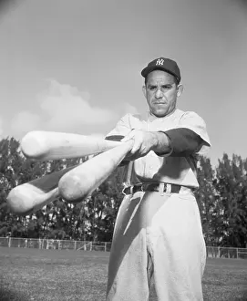 Yogi Berra Holding Three Bats