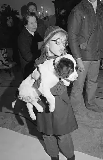 Young Amy Carter Holding Puppy