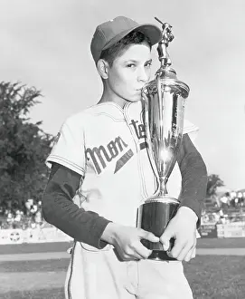 Young Angel Macias with His Baseball Trophy