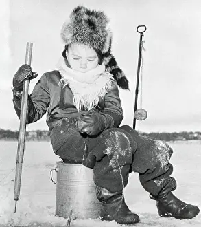 Young boy (6-7) ice fishing, Minneapolis, Minnesota, USA