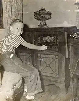 Radio Prints: Young Boy Operating a Radio in His Living Room