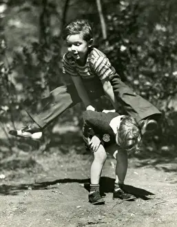Young boys playing leap frog