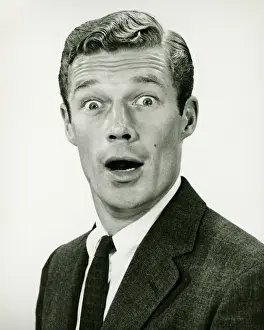 Businessman Prints: Young businessman looking surprised, posing in studio, (B&W), portrait