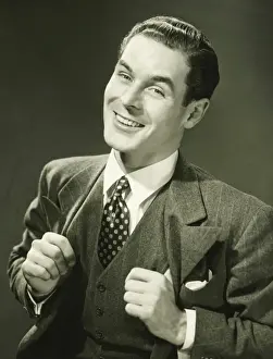 Businessman Prints: Young businessman in studio smiling, (B&W), portrait