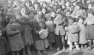 Young Children Holding Loaves of Bread
