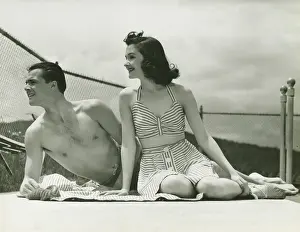 Beachwear Prints: Young couple in beachwear relaxing outdoors, (B&W)