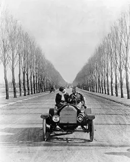 Young Couple Driving an Open Car
