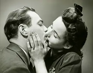Girlfriend Prints: Young couple kissing, close-up, studio shot