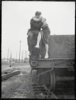 Young Couple Kissing on Railroad Car