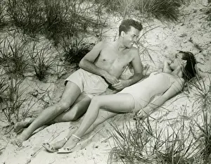 One Piece Swimsuit Prints: Young couple lying on sand, (B&W), elevated view