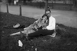 Reclining Prints: Young couple resting in park