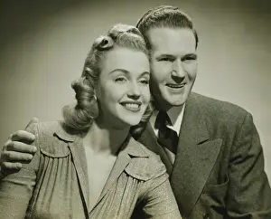 Girlfriend Prints: Young couple smiling in studio, (B&W), close-up