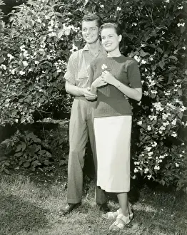 Young couple standing in garden