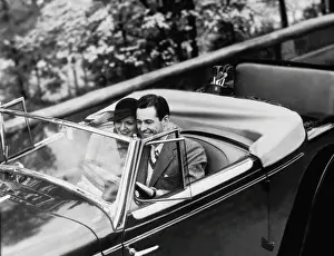 Mid Adult Couple Prints: Young Couple in Vintage Soft Top Car with Golf Clubs on Back Seat