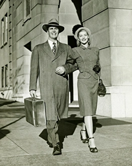 Arm In Arm Gallery: Young couple walking arm in arm on sidewalk, (B&W)