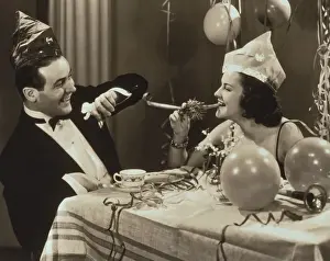 Toned Image Prints: Young couple wearing hats at party, laughing (B&W sepia tone)