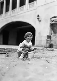 Squatting Prints: Young girl (4-5 years) playing in sand. June 06, 1929