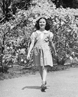 Only Girls Prints: Young girl (8-9) walking on garden path, (B&W)