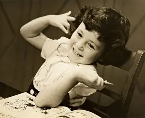Young girl with coloring book and crayon