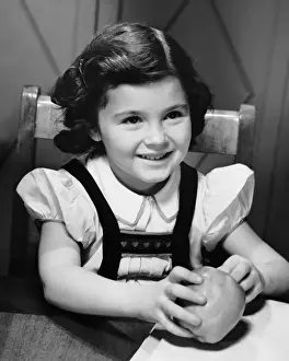 Young girl holding apple