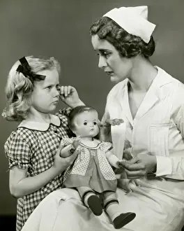 Lost Prints: Young girl and nurse holding doll
