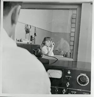 Young Hearing Impaired Girl Gesturing from Soundproof Room