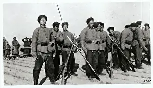 Young Male Chinese Soldiers Standing with Their Weapons