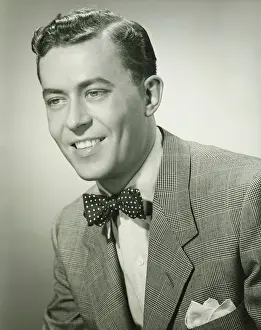 Wavy Hair Prints: Young man in bow tie posing in studio, (B&W), (Close-up), (Portrait)