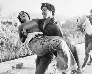 Young Man Carrying Injured Sister