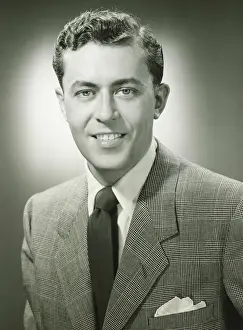 Young man in checked jacket posing in studio, (B&W), (Close-up), (Portrait)