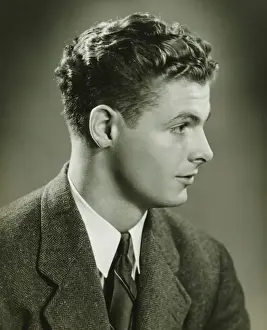 Sleek Hair Prints: Young man posing in studio, (B&W), close-up, portrait
