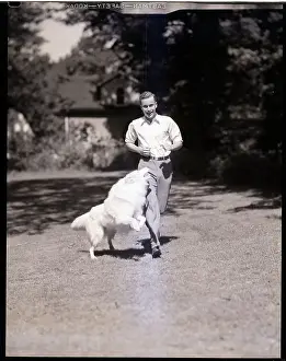 Young Man Running with Collie