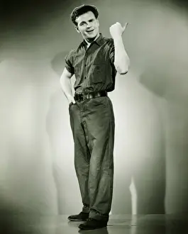 Hand On Hip Prints: Young man standing in studio, gesturing, (B&W)