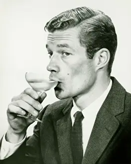 Enjoyment Prints: young man in suit, drinking wine (B&W), portrait