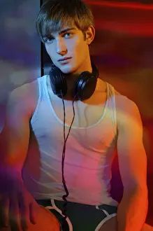 Thoughtful Prints: Young man in underwear with headphones in colorful light