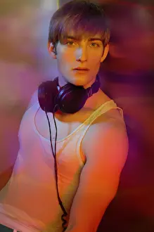 Airy Prints: Young man in underwear with headphones in colorful lightYoung man in underwear with headphones in colorful light
