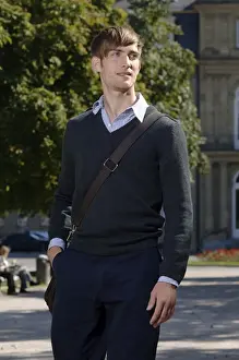 Jumper Prints: Young man wearing elegant clothing with a bag over his shoulder in front of the New Palace in Stuttgart