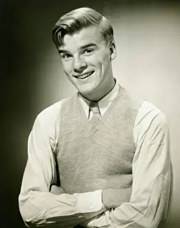Jumper Prints: Young man wearing jumper, smiling, (B&W), portrait