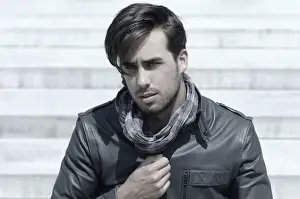 Introspection Prints: Young man wearing a leather jacket in front of an open staircase