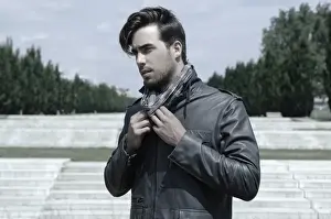 Contemplates Prints: Young man wearing a leather jacket in front of an open staircase, portrait
